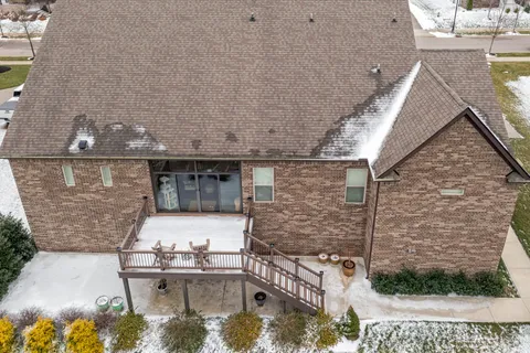 an aerial view of a house with a yard and lake view