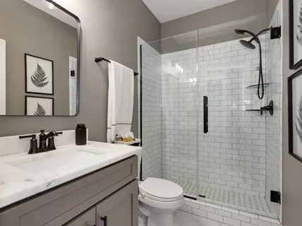 a bathroom with a sink a toilet and shower