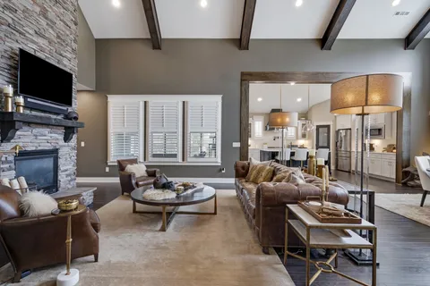 a living room with furniture a flat screen tv and a fireplace