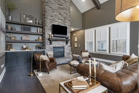 a living room with furniture a fireplace and a flat screen tv