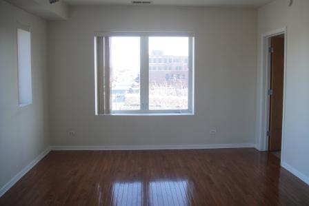6238 West 26th Street, Unit 504 Berwyn, IL 60402 - Photo 2 of 8 an empty room with wooden floor and windows