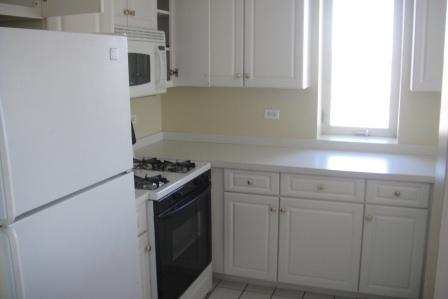 6238 West 26th Street, Unit 504 Berwyn, IL 60402 - Photo 6 of 8 a kitchen with white cabinets and white appliances