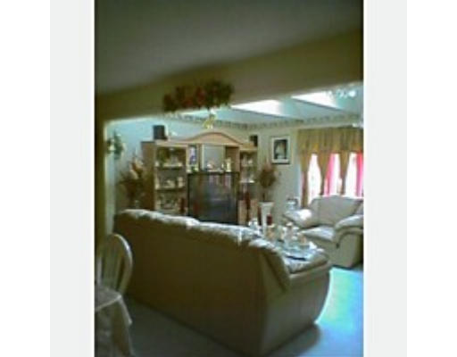 235 Gresham Street Springfield, MA 01119 - Photo 3 of 7 a living room with furniture and a potted plant