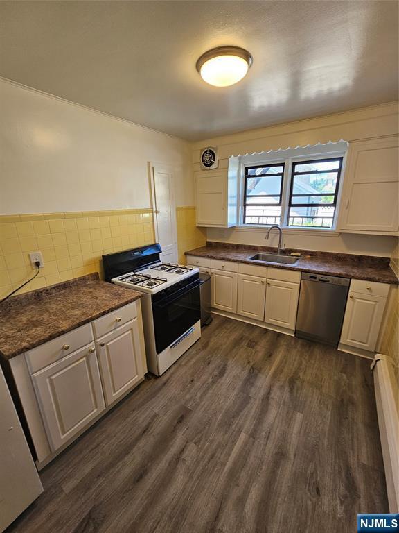 75 East Fort Lee Road, Unit 1 Bogota, NJ 07603 - Photo 7 of 8 a kitchen with stainless steel appliances granite countertop a stove a sink and a refrigerator