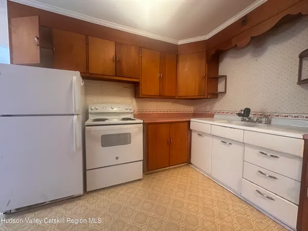a kitchen with cabinets stainless steel appliances and sink