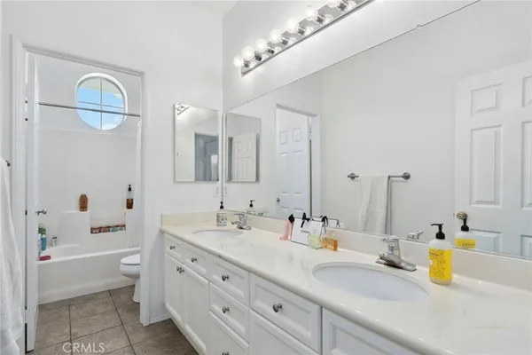 a bathroom with a tub a sink and mirror