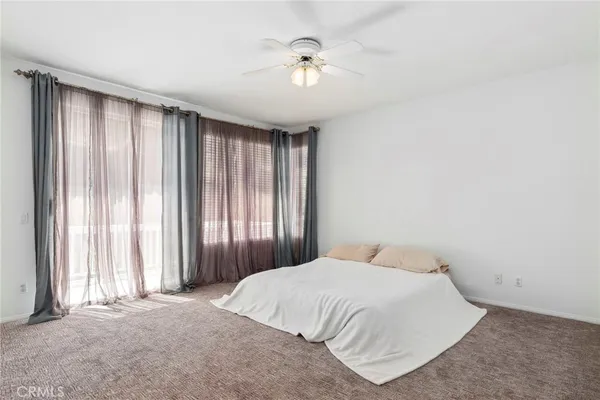 a bedroom with a large bed and a chandelier