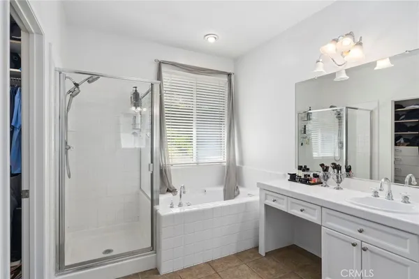 a bathroom with a bathtub a sink and mirror