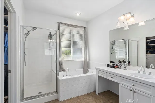 a bathroom with a bathtub a sink and mirror