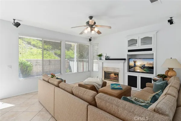 a living room with furniture fireplace and flat screen tv