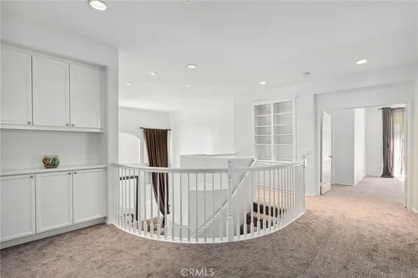 a view of staircase with white walls