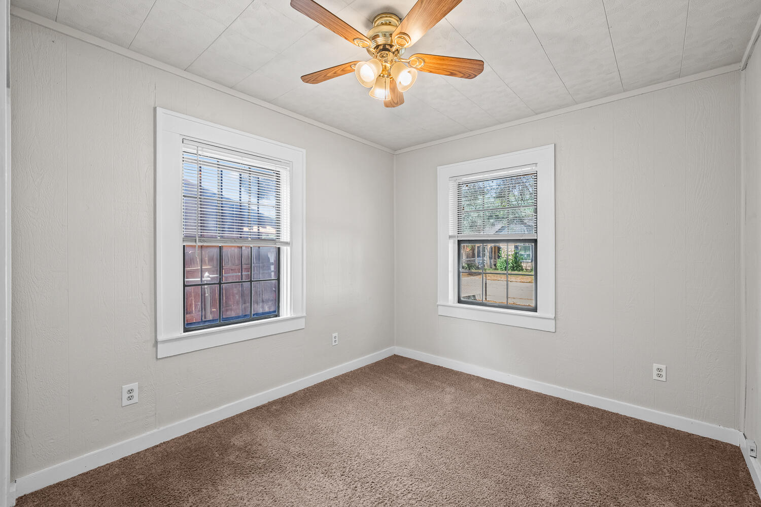 2313 20th Street Lubbock, TX 79411 - Photo 12 of 21 an empty room with windows and fan