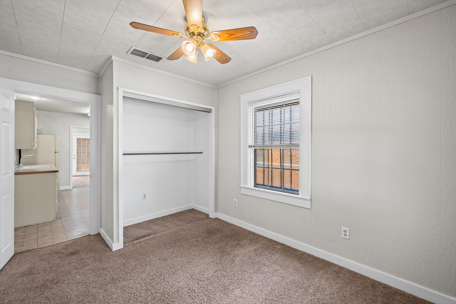 2313 20th Street Lubbock, TX 79411 - Photo 13 of 21 an empty room with windows and a ceiling fan