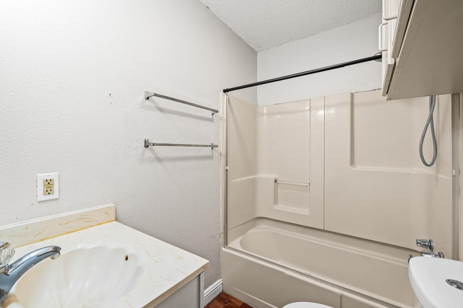 2313 20th Street Lubbock, TX 79411 - Photo 14 of 21 a bathroom with a bathtub and a sink