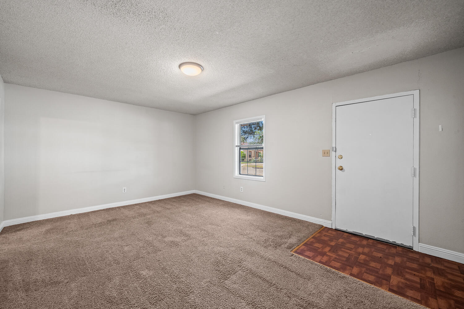 2313 20th Street Lubbock, TX 79411 - Photo 5 of 21 a view of an empty room and a window