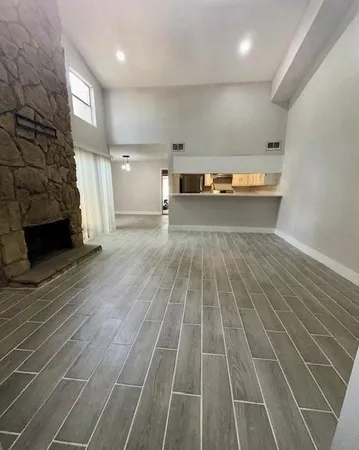a view of a room with wooden floor and staircase
