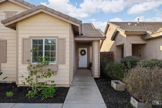 a view of a house with potted plants