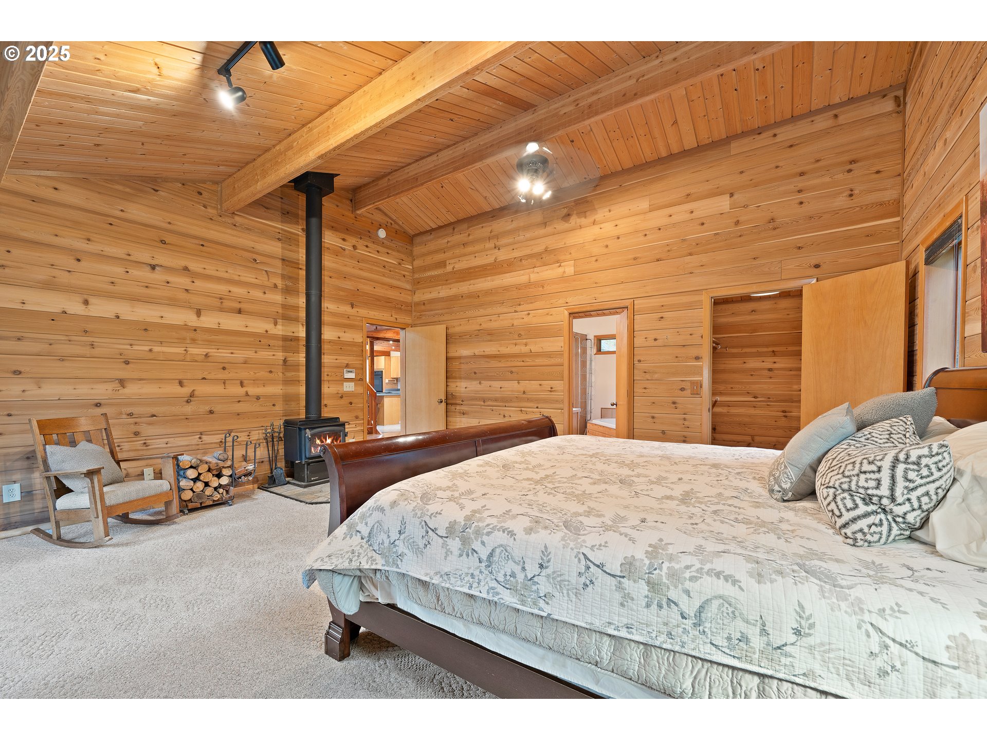 1261 Mathews Road Washougal, WA 98671 - Photo 15 of 42 a bedroom with a bed lamp and a large window