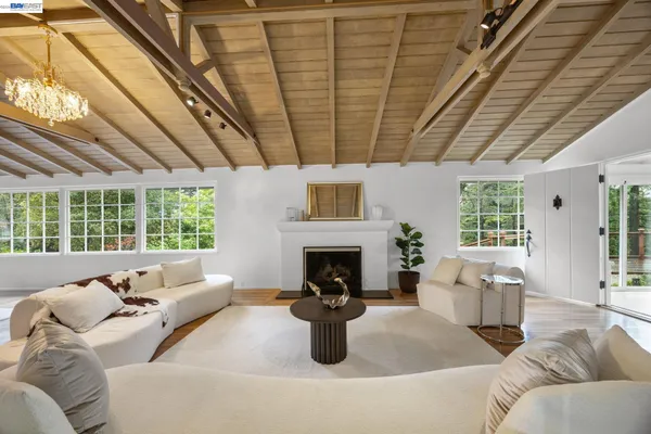 a living room with furniture fireplace and a large window