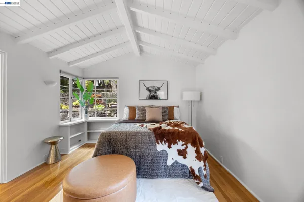 a bedroom with a bed and a large window