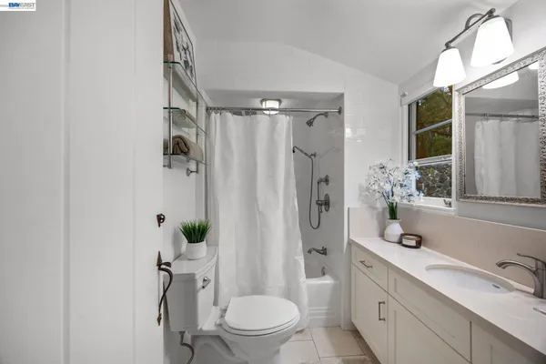 a bathroom with a shower sink vanity mirror and toilet