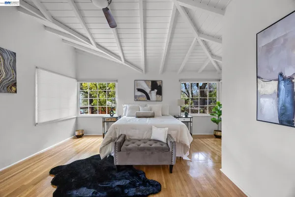a bedroom with a bed window and dresser