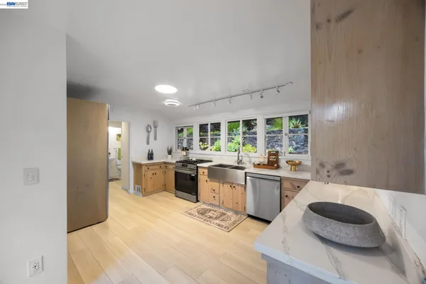 a kitchen with stainless steel appliances granite countertop a sink and cabinets