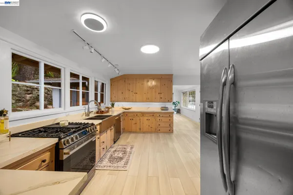 a kitchen with stainless steel appliances granite countertop a stove and a refrigerator