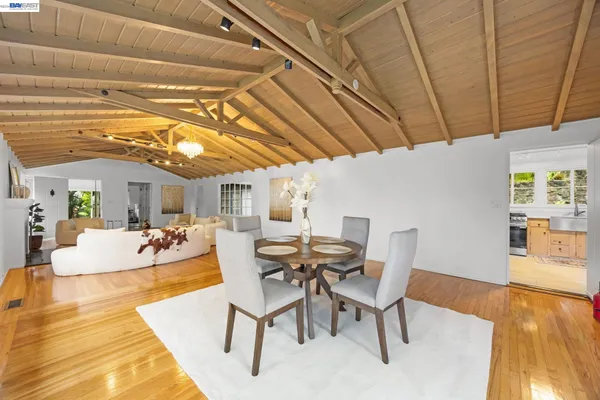 a view of a dining room with furniture and wooden floor