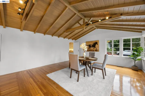 a view of a dining room with furniture and wooden floor