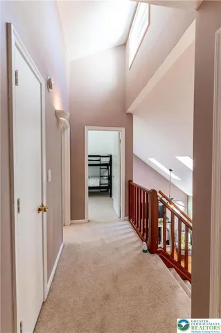 a view of a hallway with closet and a couch