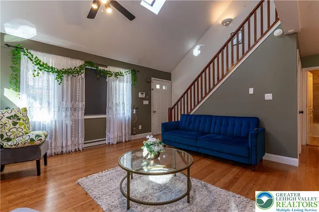 a living room with furniture and a potted plant