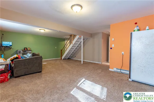 a view of a livingroom with furniture and a ceiling fan