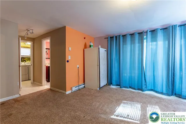 an empty room with windows and closet