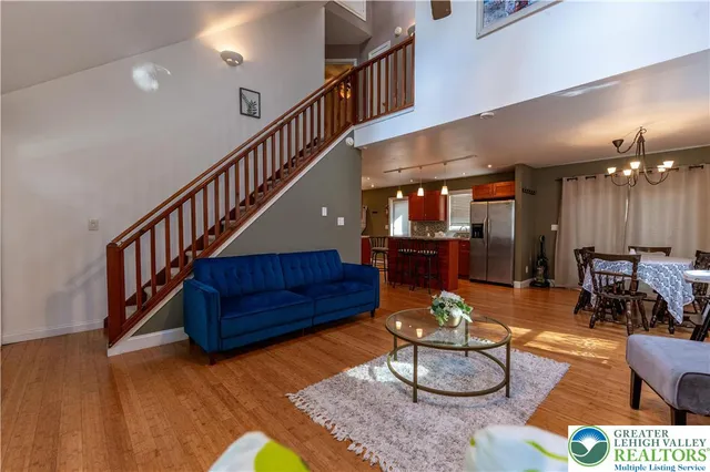 a living room with furniture pool table and a rug