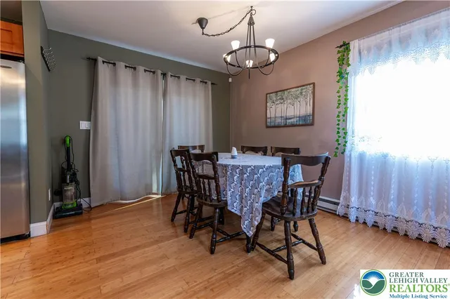 a view of a dining room with furniture window and wooden floor