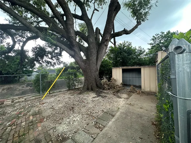 a view of a wooden house with a tree