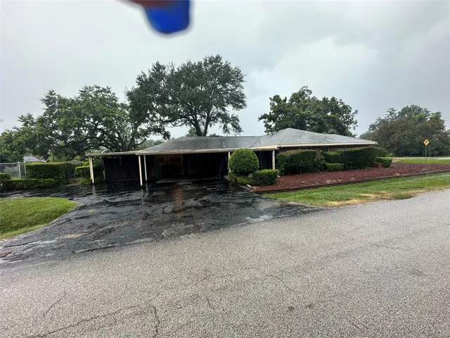 a view of a house with backyard and sitting area