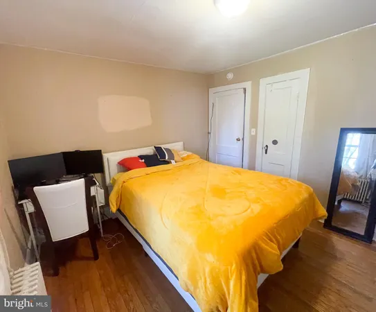 a bed sitting in a bedroom next to a lamp