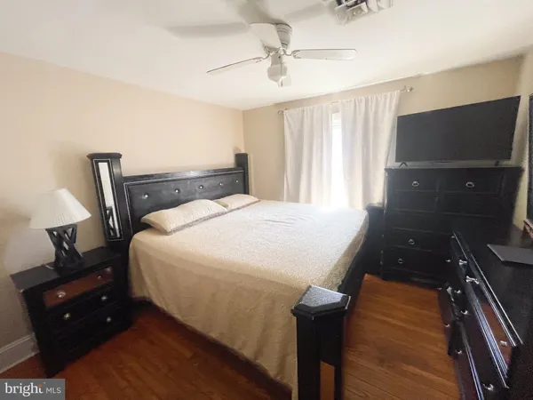 a bedroom with a bed and a mirror