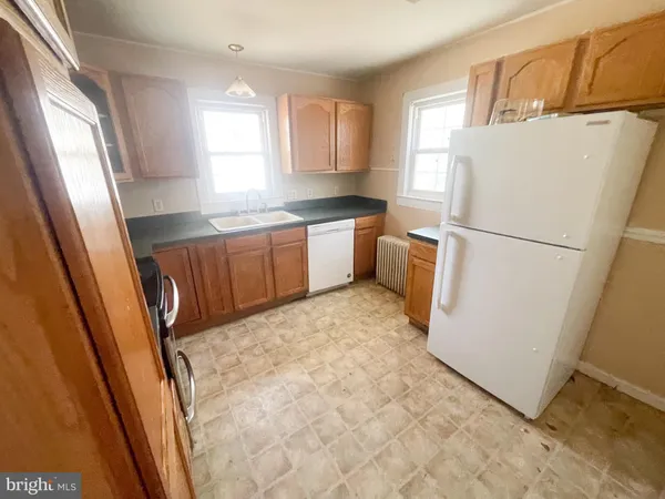 a white refrigerator freezer sitting inside of a kitchen