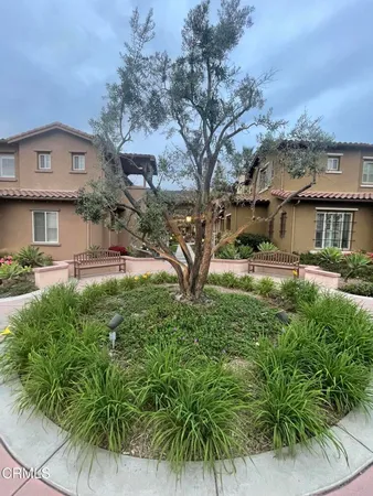 a view of a house with a yard and sitting area