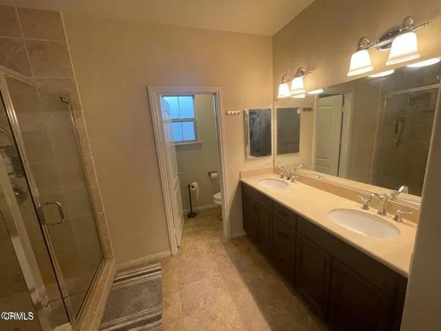 a bathroom with a double vanity sink a and mirror