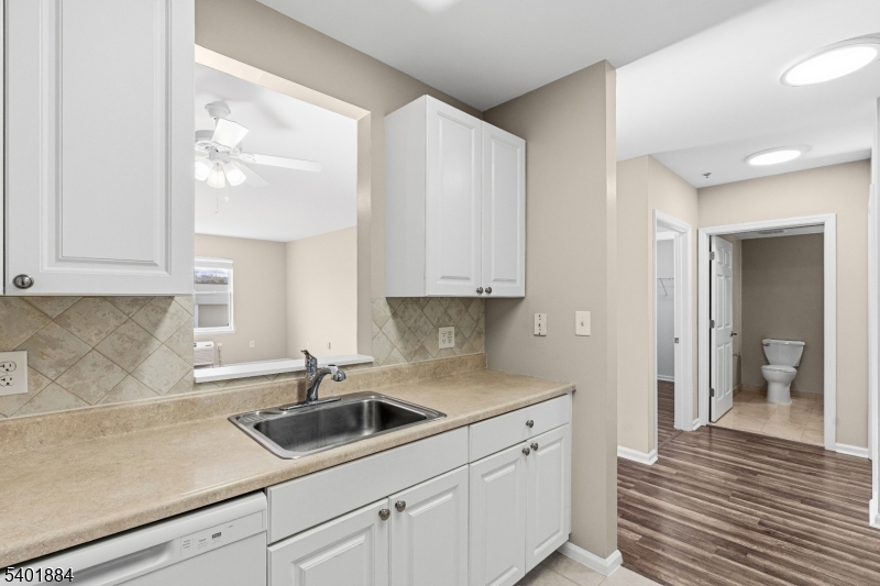 905 River Road, Unit 224 Edgewater, NJ 07020 - Photo 12 of 14 a kitchen with white cabinets and sink