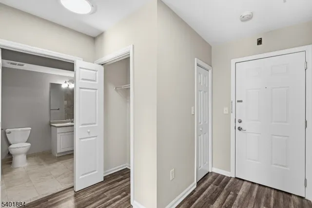 a bathroom view of a toilet and a mirror