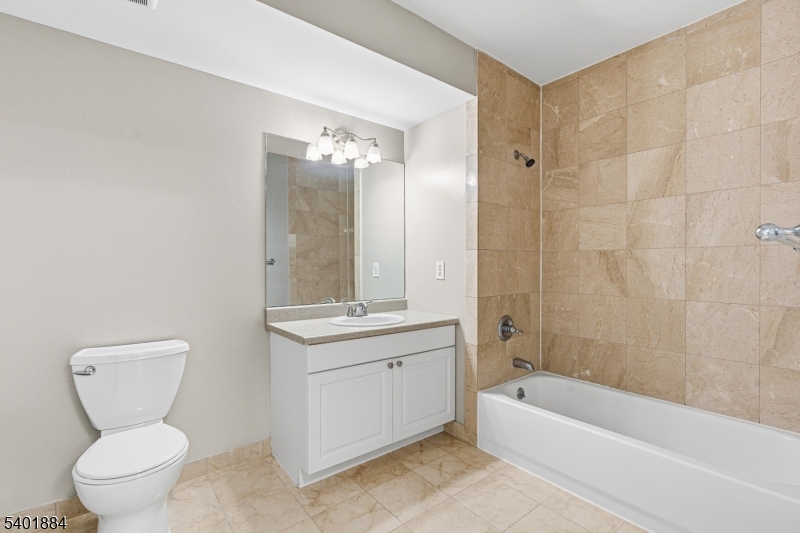 905 River Road, Unit 224 Edgewater, NJ 07020 - Photo 7 of 14 a bathroom with a toilet sink and bathtub