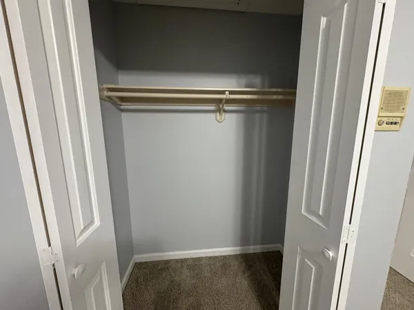 a spacious bathroom with a double vanity sink a mirror and a toilet