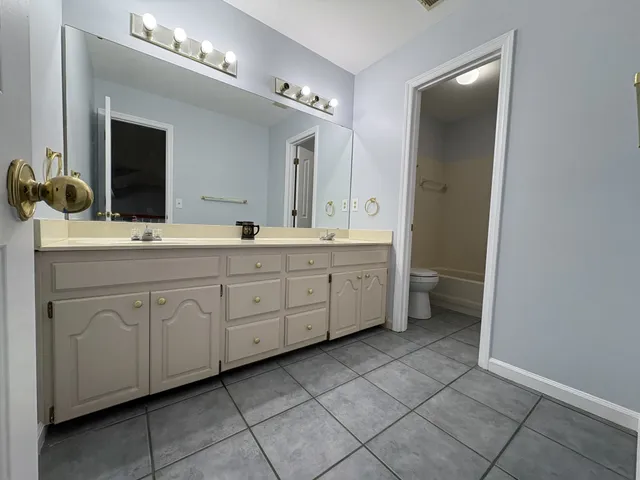 a bathroom with a toilet and a bath tub