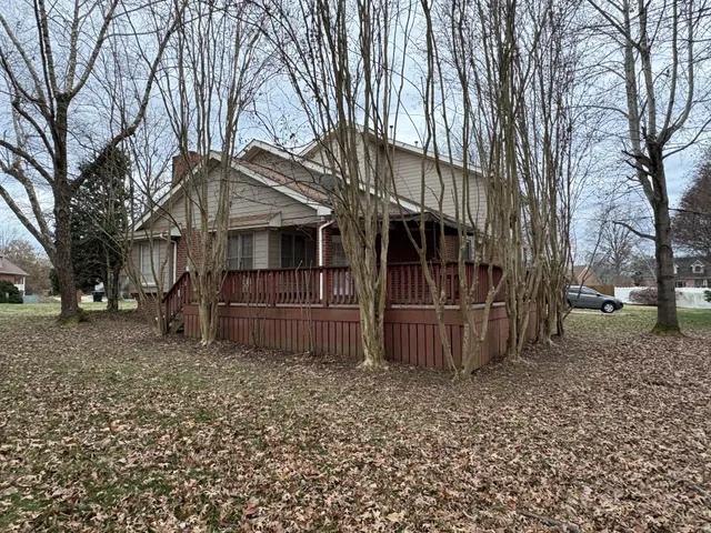 a front view of house with a garden