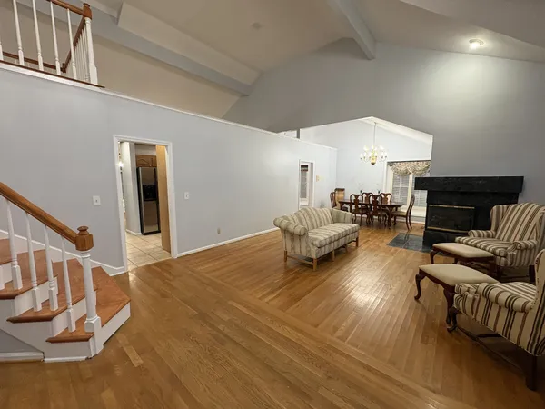 a living room with furniture and a chandelier